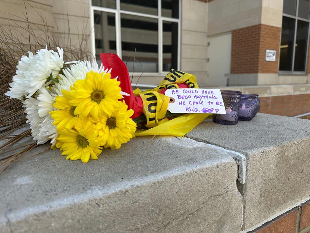 FILE - A bouquet of flowers with a note and votive candles sits at the entrance of Constant Hall at Old Dominion University in Norfolk, Va., on March 13, 2026. (AP Photo/Allen G. Breed, File)