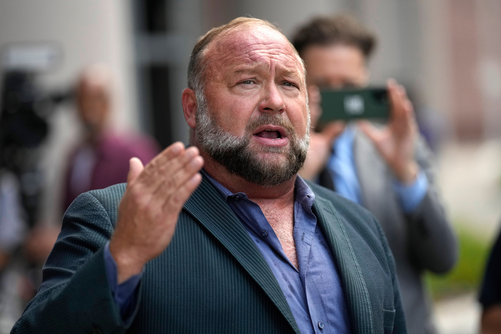 FILE - Right-wing conspiracy theorist Alex Jones speaks to the media after arriving at the federal courthouse for a hearing in front of a bankruptcy judge, June 14, 2024, in Houston. (AP Photo/David J. Phillip, File)