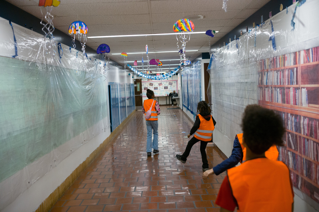 Students wearing orange vests roam the halls at Clairton Education Center, visiting classrooms and informing classmates of their MicroSociety venture at Clairton Education Center in Clairton, Pa., on Thursday, Jan. 22, 2026. (Quinn Glabicki/Pittsburgh's Public Source via AP)