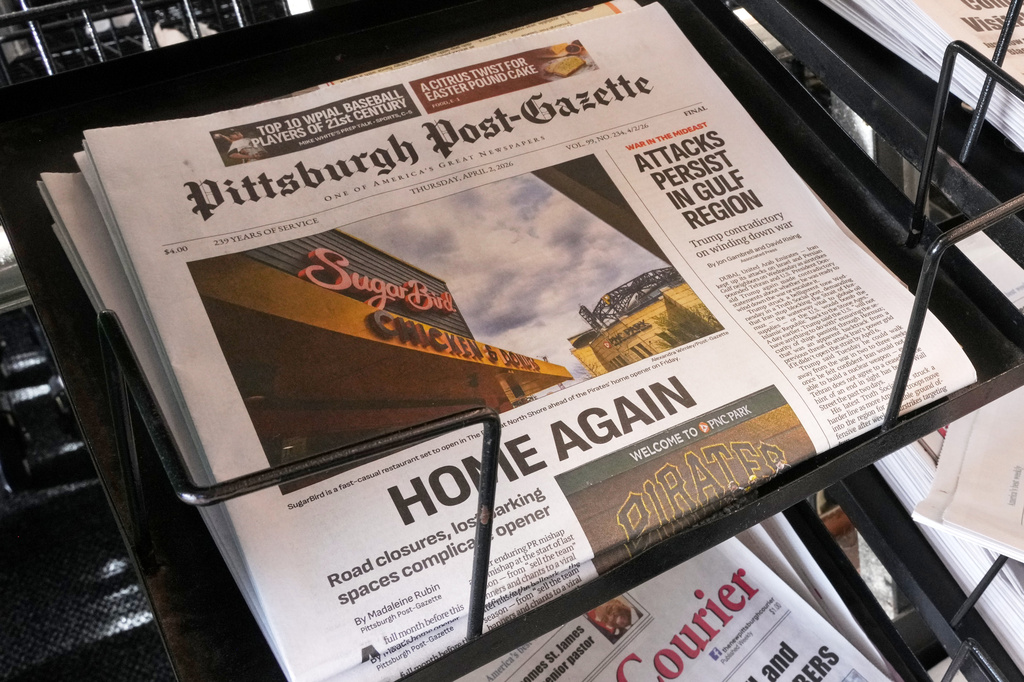 The printed edition of the Pittsburgh Post-Gazette sits in a newspaper rack, Thursday, April 2, 2026, in Pittsburgh. (AP Photo/Gene J. Puskar)