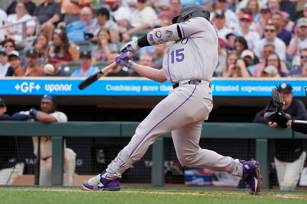 Colorado Rockies' Hunter Goodman hits a solo home run against the Minnesota Twins in the first inning of a baseball game Saturday, June 27, 2026, in Minneapolis. (AP Photo/Bruce Kluckhohn)