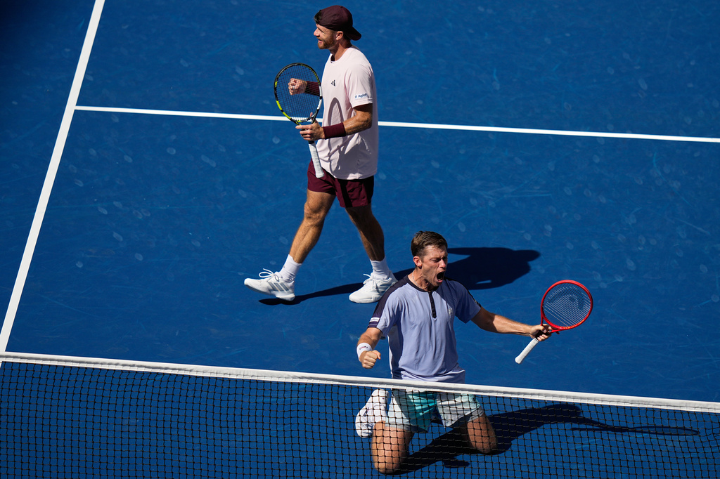 Neal Skupski, of Britain, bottom, celebrates with Christian Harrison, of the United States, top, after winning the men's doubles final of the U.S. Open tennis championships Kevin Krawietz, of Germany, and Tim Puetz, of Germany, Saturday, Sept. 12, 2026, in New York. (AP Photo/Frank Franklin II)