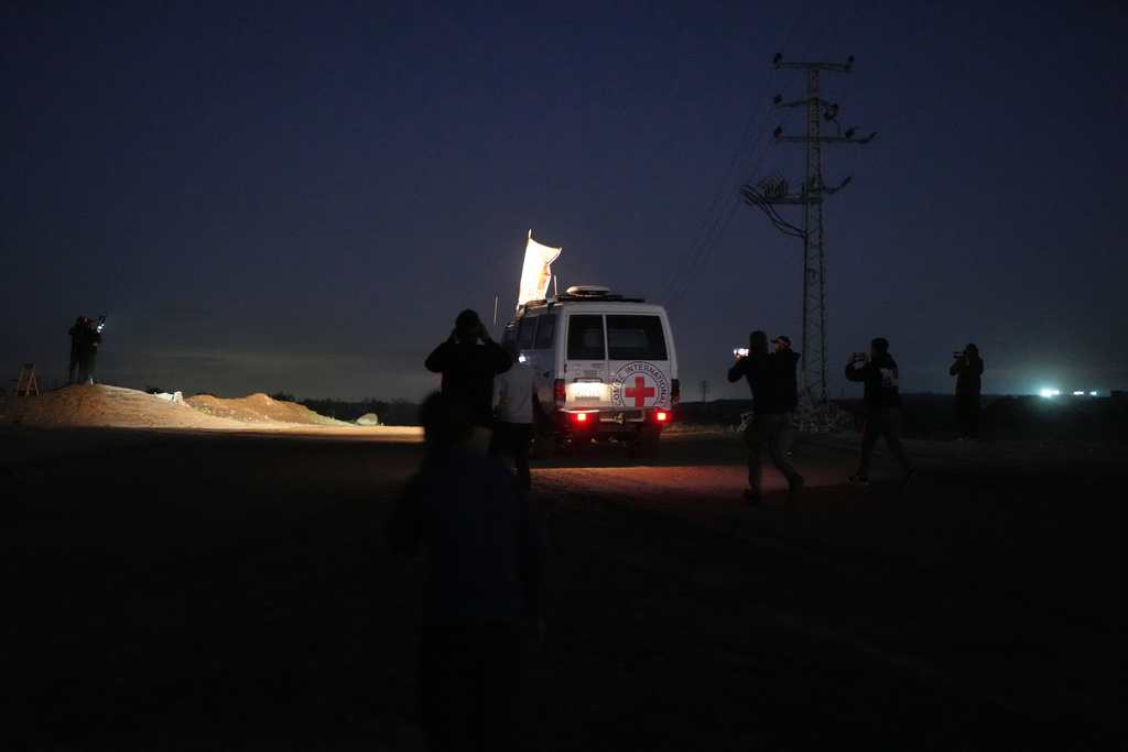 Red Cross convoy carrying the remains of a person believed to be a deceased hostage handed over by Gaza militants makes its way toward the border crossing with Israel, to be transferred to Israeli authorities, in Deir al-Balah, central Gaza Strip, Tuesday, Nov. 25, 2025. (AP Photo/Abdel Kareem Hana)
