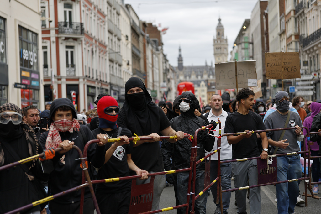 Protesters of the of the "Block Everything" movement setting a barricade during a rally in Lille, northern France, Wednesday, Sept. 10, 2025. (AP Photo/Jean-Francois Badias)