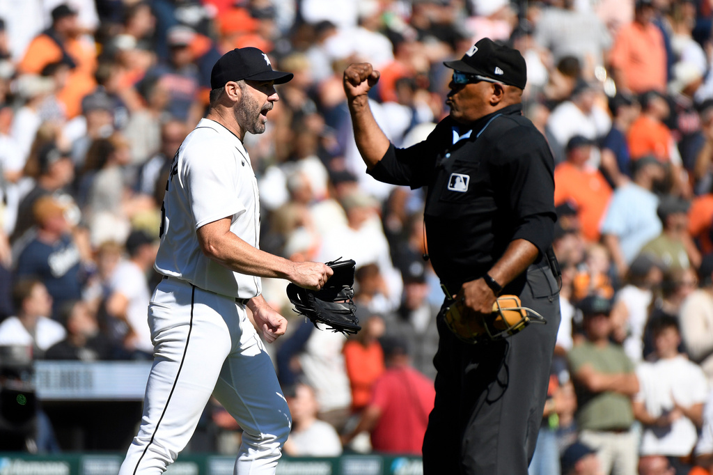 Home plate umpire Laz Diaz, right, rules the Pittsburgh Pirates' final out of the fifth inning in a baseball game as Detroit Tigers starting pitcher Justin Verlander reacts d, Saturday, Sept. 26, 2026, in Detroit. (AP Photo/Jose Juarez)
