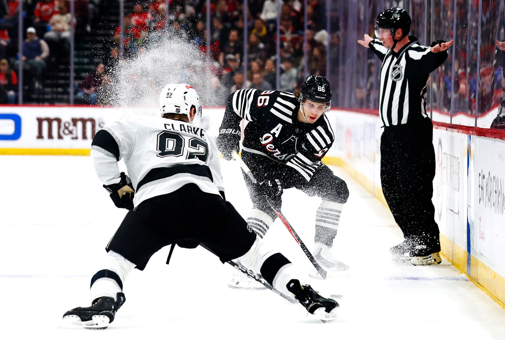 New Jersey Devils center Jack Hughes (86) controls the puck against Los Angeles Kings defenseman Brandt Clarke (92) during the second period of an NHL hockey game, Saturday, March 14, 2026, in Newark, N.J. (AP Photo/Noah K. Murray)