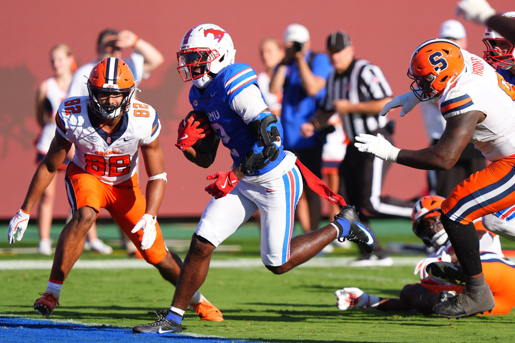 SMU wide receiver Jordan Hudson (2) scores a touchdown against Syracuse defenders Jamie Tremble (82) and Isaiah Hastings (9) during the second half of an NCAA college football game Saturday, Oct. 4, 2025, in Dallas. (AP Photo/LM Otero)