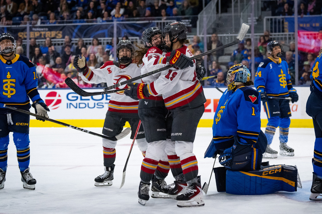 Ottawa Charge forward Brianne Jenner (19) celebrates with teammates after her goal against Toronto Sceptres goaltender Raygan Kirk (1) during third-period PWHL hockey game action in Toronto, Saturday, April 11, 2026. (Arlyn McAdorey/The Canadian Press via AP)