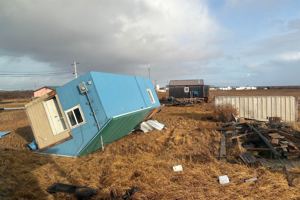 An unoccupied home rests on it's roof after being knocked over in Kotlik, Alaska, Sunday, Oct. 12, 2025, after the remnants of Typhoon Halong hit western Alaska. (AP Photo/Adaline Pete)
