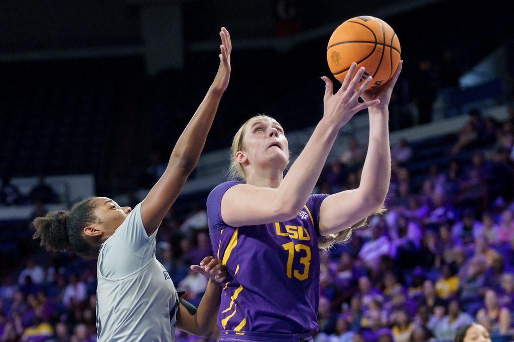 LSU forward Kate Koval (13) shoots against New Orleans guard Lauren Banks during the first half of an NCAA college basketball game, Sunday, Dec. 7, 2025, in New Orleans. (AP Photo/Matthew Hinton)
