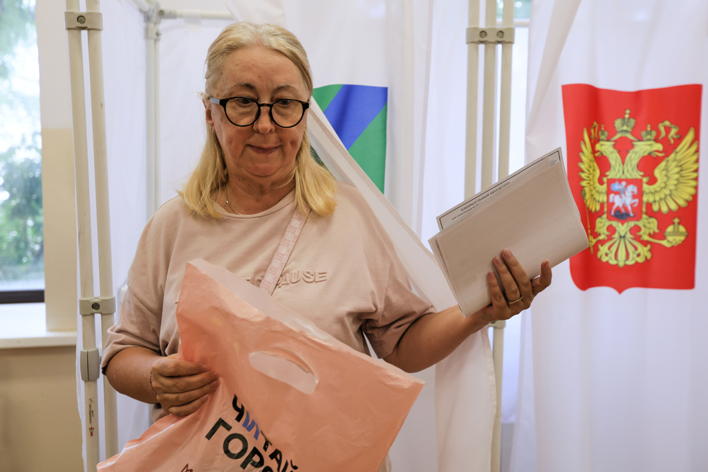 A woman walks to cast her ballot in the parliamentary election in Vladivostok, Russia, Friday, Sept. 18, 2026. (AP Photo)