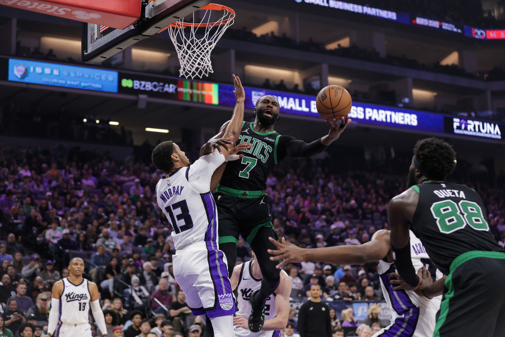 Boston Celtics guard Jaylen Brown (7) attempts a layup over Sacramento Kings forward Keegan Murray (13) during the first half of an NBA basketball game Thursday, Jan. 1, 2026, in Sacramento, Calif. (AP Photo/Scott Marshall)