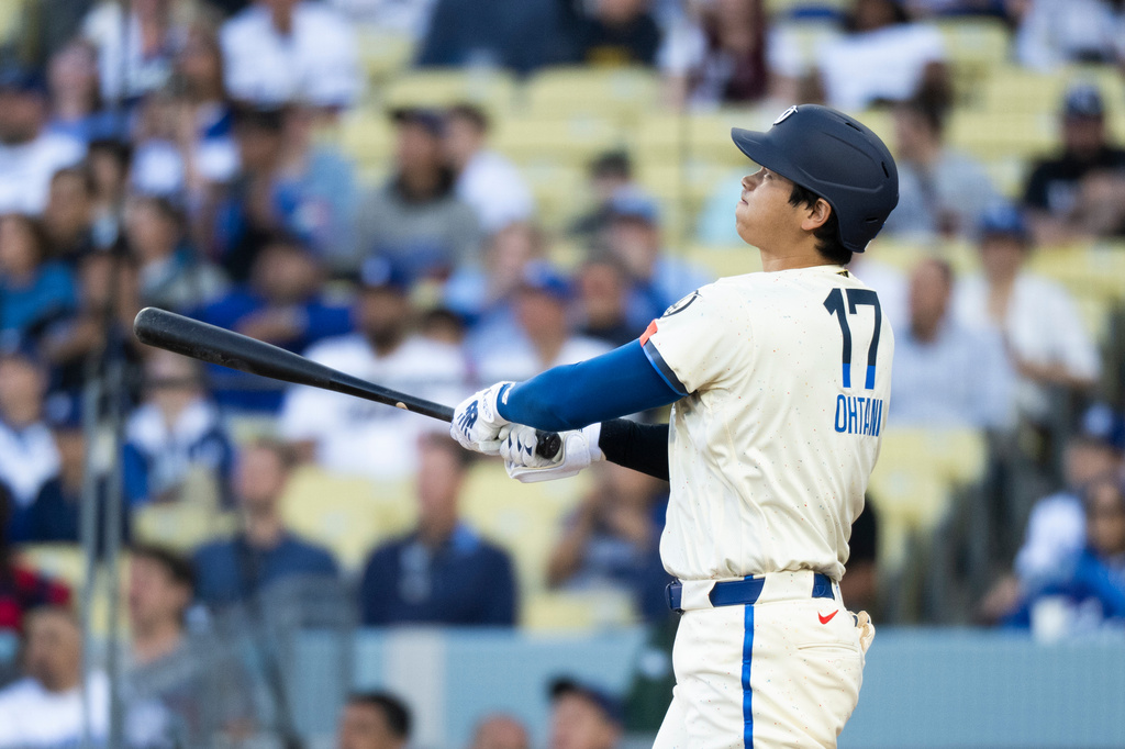 Los Angeles Dodgers' Shohei Ohtani watches his solo home run during the first inning of a baseball game against the Texas Rangers in Los Angeles, Saturday, April 11, 2026. (AP Photo/Kyusung Gong)