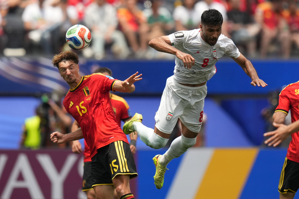 Belgium's Thomas Meunier, left, heads the ball past Iran's Mohammad Mohebbi during the World Cup Group G soccer match between Belgium and Iran in Inglewood, Calif., near Los Angeles, Sunday, June 21, 2026. (AP Photo/Andre Penner)