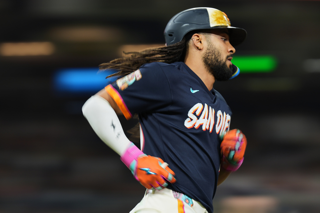 San Diego Padres' Fernando Tatis Jr. watches his single during the seventh inning of a baseball game against the Houston Astros Friday, Aug. 7, 2026, in San Diego. (AP Photo/Gregory Bull)