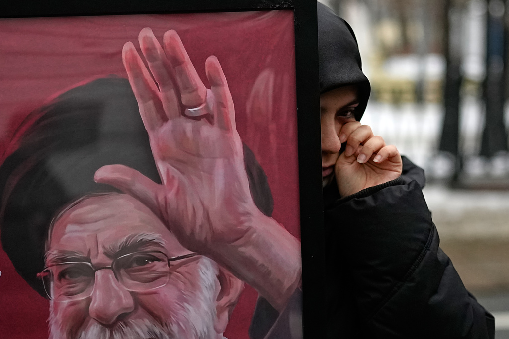 An Iranian woman wipes away a tear as other studiens studying in Russia gather at a memorial set up for the late Iranian Supreme Leader Ayatollah Ali Khamenei, who was killed during U.S. and Israeli strikes on Iran, outside Iran's embassy in Moscow, Monday, March 2, 2026. (AP Photo/Alexander Zemlianichenko)