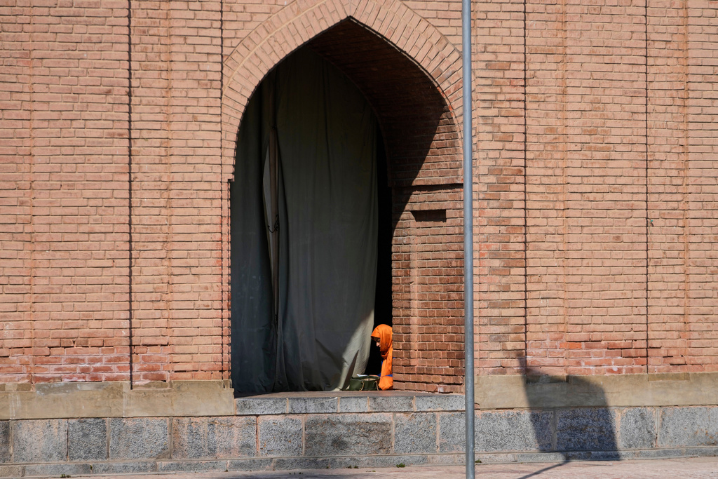 A Kashmiri Muslim woman reads the Islamic holy book, the Quran, on the first day of the holy month of Ramadan at Jamia Masjid or Grand Mosque in Srinagar, Indian controlled Kashmir, Thursday, Feb. 19, 2026. (AP Photo/Mukhtar Khan)