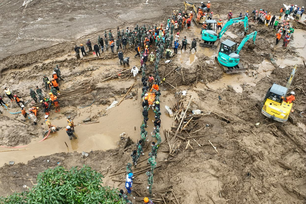 In this photo released by Indonesia's National Disaster Management Agency (BNPB) rescuers search for victims in Pasir Langu village after a landslide, in West Bandung district of West Java province, Indonesia, Monday, Jan. 26, 2026. (BNPB via AP)