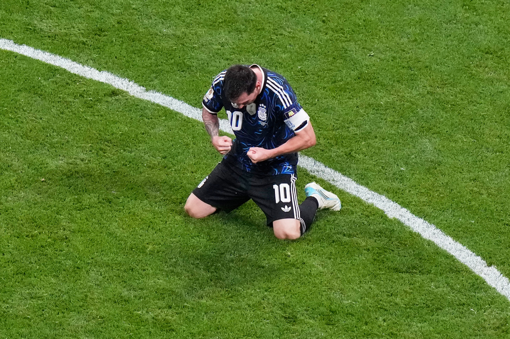 Argentina's Lionel Messi (10) kneels on the pitch as he celebrates defeating England in their World Cup semifinal soccer match in Atlanta, Wednesday, July 15, 2026. (AP Photo/Lynne Sladky)
