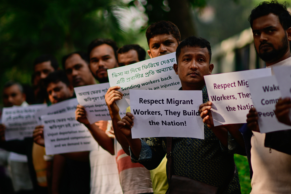 Bangladeshi workers who were employed by Malaysian companies protest in front of the Ministry of Expatriates' Welfare and Overseas Employment demanding unpaid wages, fair compensation and an end to alleged abuse by Malaysian employers, in Dhaka, Bangladesh, Monday, Nov. 10, 2025. (AP Photo/Mahmud Hossain Opu)
