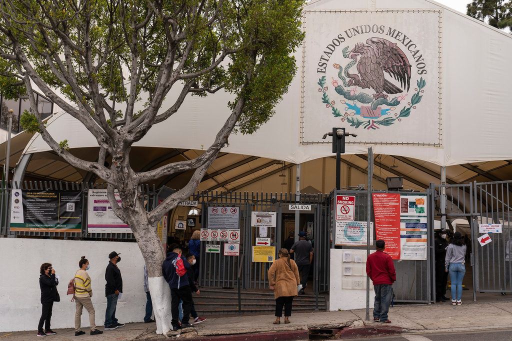 FILE - People line up for services at the Mexican Consulate in Los Angeles, May 8, 2021. (AP Photo/Damian Dovarganes, File)