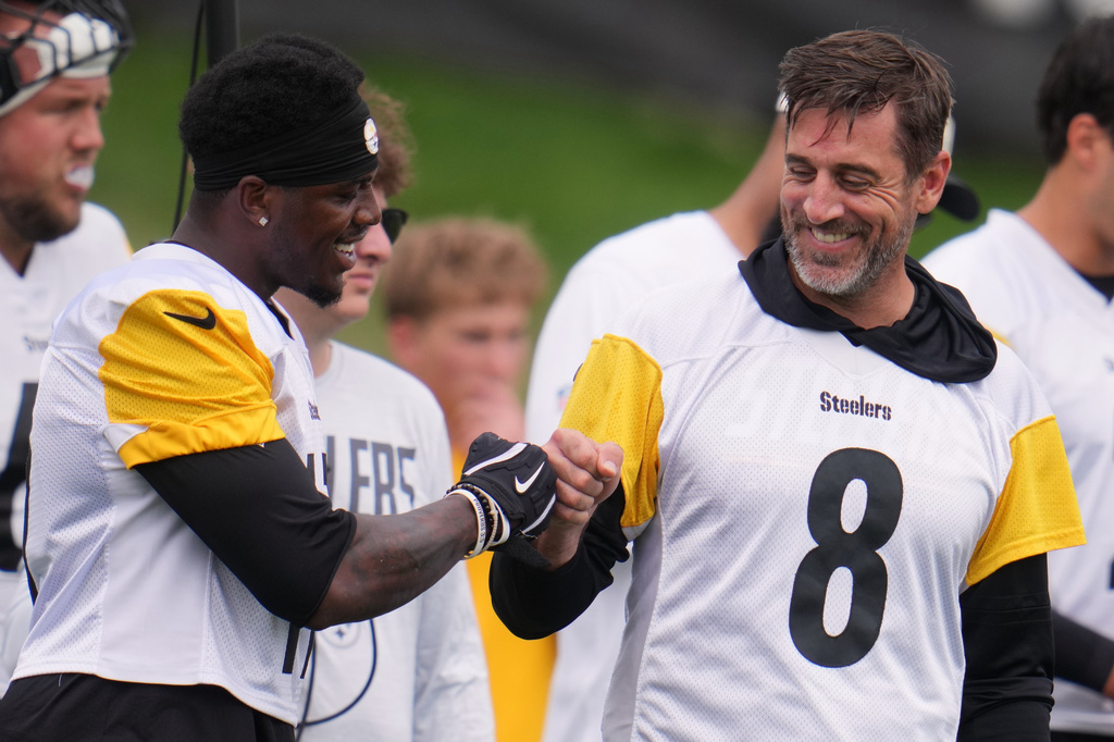 Pittsburgh Steelers quarterback Aaron Rodgers (8) fist bumps wide receiver Germie Bernard, left during the NFL team's training camp in Latrobe, Pa., Saturday, Aug. 1, 2026. (AP Photo/Gene J. Puskar)