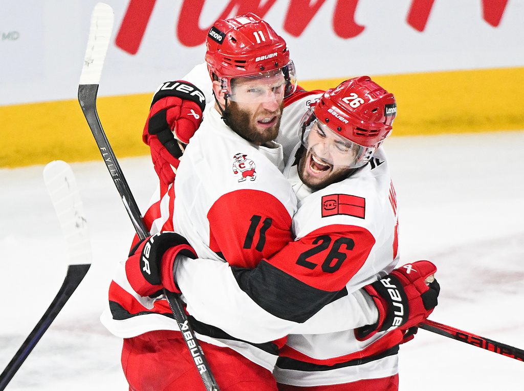 Carolina Hurricanes' Jordan Staal (11) celebrates with teammate Sean Walker (26) after scoring against the Montreal Canadiens during the first period of Game 4 of NHL Eastern Conference final Stanley Cup playoff series action in Montreal, Quebec, Wednesday, May 27, 2026. (Graham Hughes/The Canadian Press via AP)
