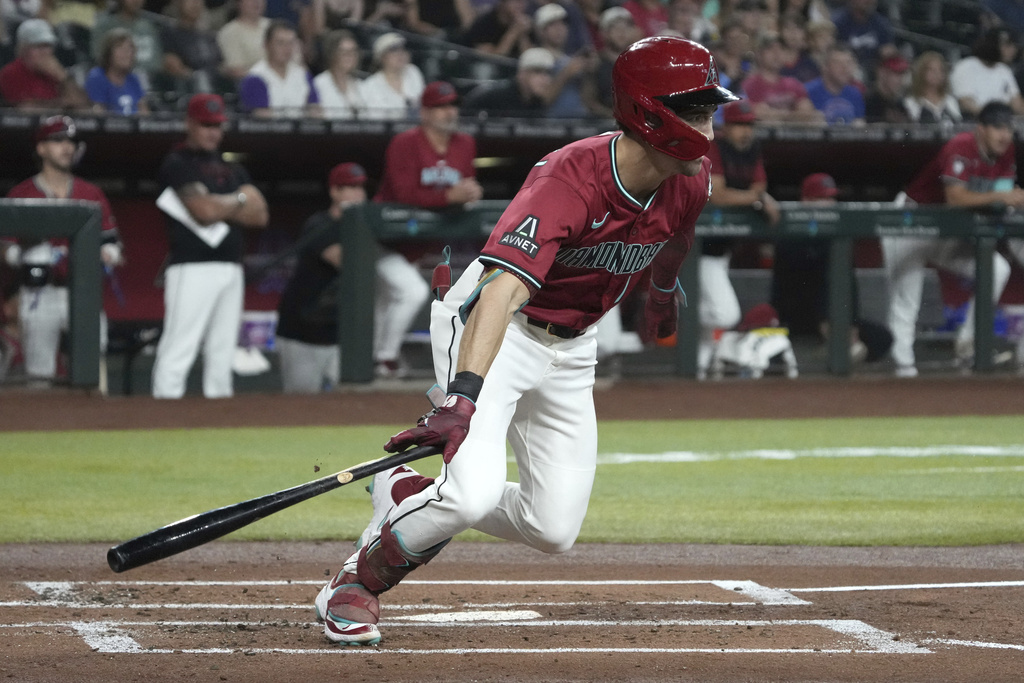 Arizona Diamondbacks' Corbin Carroll starts to run after hitting into a fielder's choice RBI in the first inning of a baseball game against the Philadelphia Phillies, Sunday, Sept. 21, 2025, in Phoenix. (AP Photo/Rick Scuteri)