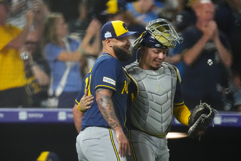 Milwaukee Brewers relief pitcher Drew Rom, left, congratulates catcher William Contreras after defeting the Colorado Rockies in a baseball game Saturday, June 6, 2026, in Denver. (AP Photo/David Zalubowski)