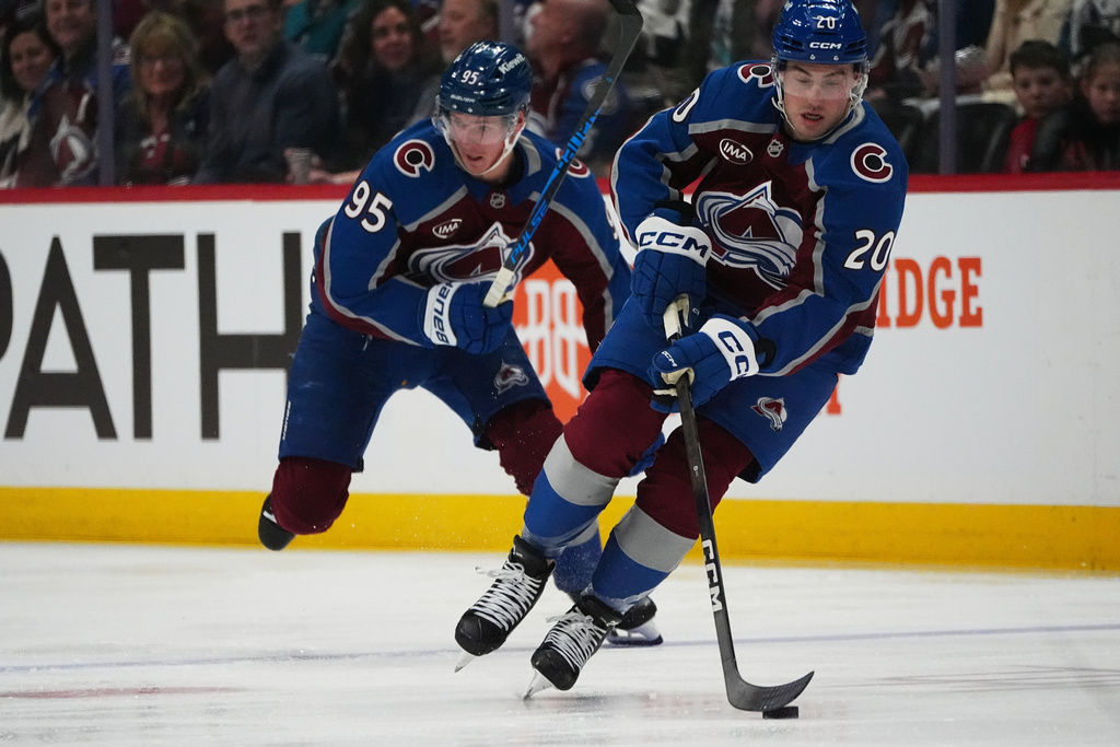 Colorado Avalanche center Ross Colton, fornt, collects a loose puck as left wing Victor Olofsson trails in the first period of an NHL hockey game against the San Jose Sharks, Wednesday, Feb. 4, 2026, in Denver. (AP Photo/David Zalubowski)