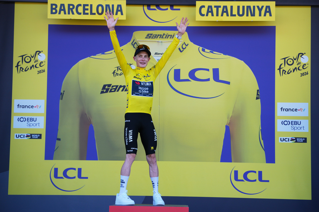 Denmark's Jonas Vingegaard celebrates on the podium after wining the first stage of the Tour de France cycling race, a team time-trial over 19.6 kilometers (11.8 miles) with start and finish in Barcelona, Spain, Saturday, July 4, 2026. (AP Photo/Thibault Camus)