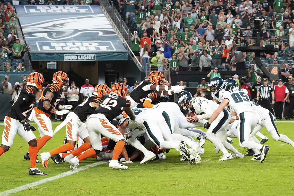 Philadelphia Eagles quarterback Tanner McKee (16) scores a touchdown on a tush push play during the first half of an NFL preseason football game against the Cincinnati Bengals on Thursday, Aug. 7, 2025, in Philadelphia. (AP Photo/Chris Szagola)