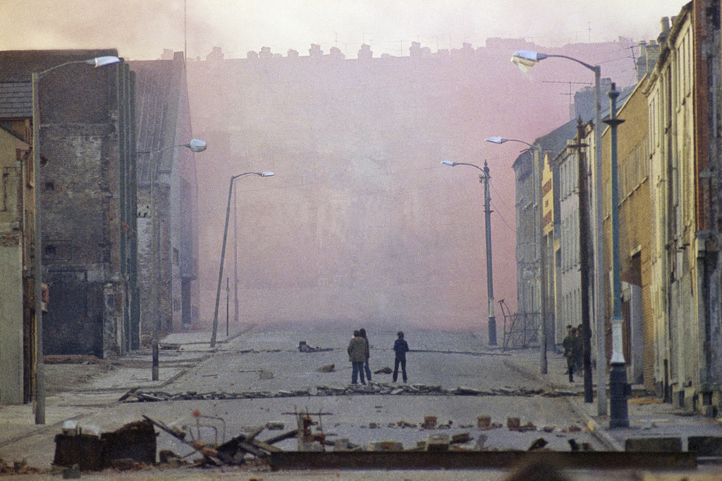 FILE - Haze from smoke bombs released by British troops in the bogside district of Londonderry, Northern Ireland, on Feb. 1, 1972. (AP Photo/Michel Laurent, File)