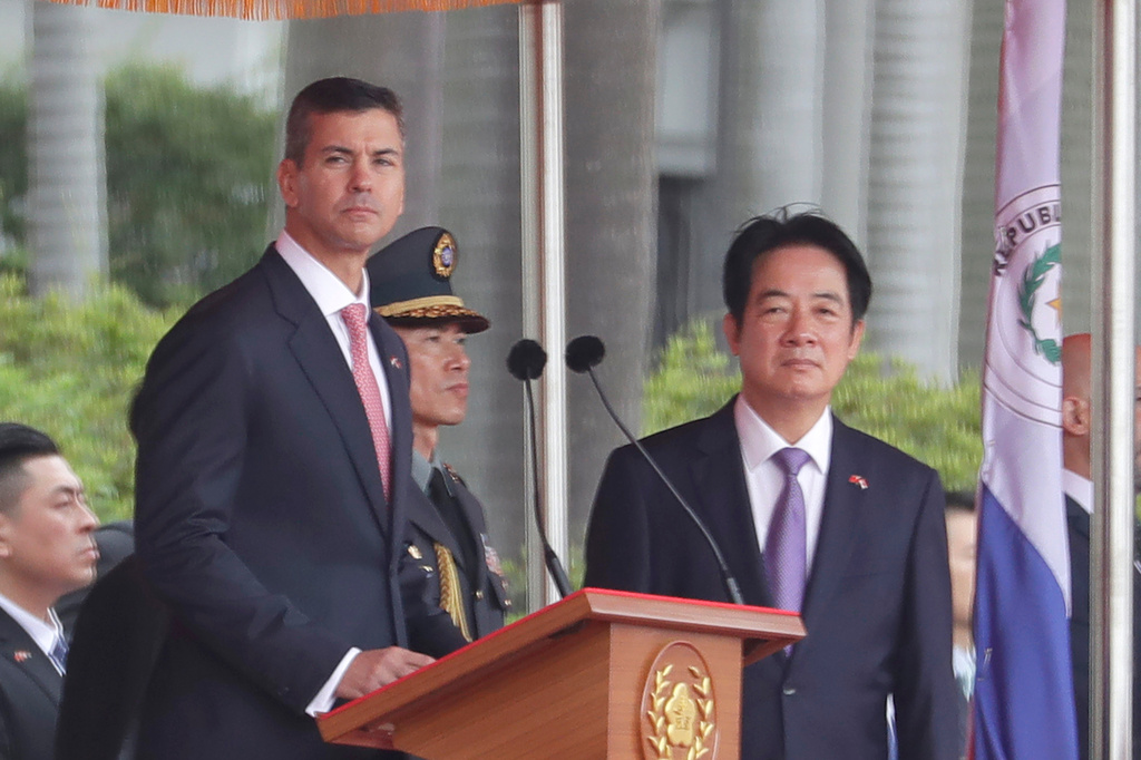 Paraguayan President Santiago Pena, left, accompanied by Taiwan President Tsai Ing-wen, delivers a speech during a military welcome ceremony in Taipei, Taiwan, Friday, May 8, 2026. (AP Photo/Chiang Ying-ying)