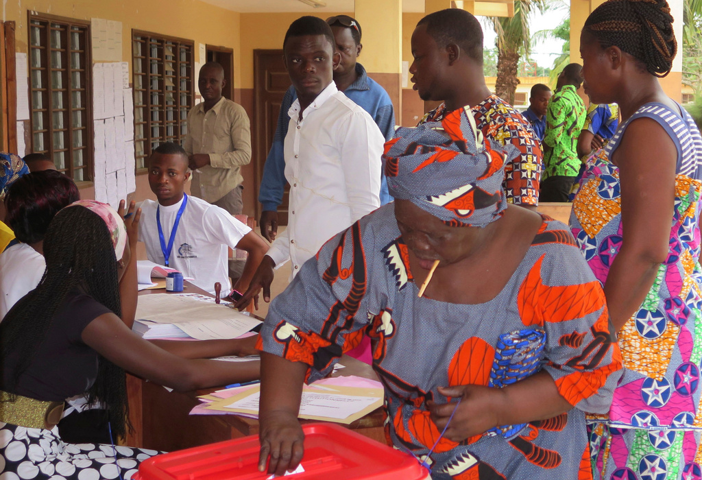 FILE - A woman casts her vote at a polling station during an election, in Seme Podji, Benin, March 6, 2016. (AP Photo/Virgile Ahissou, File)