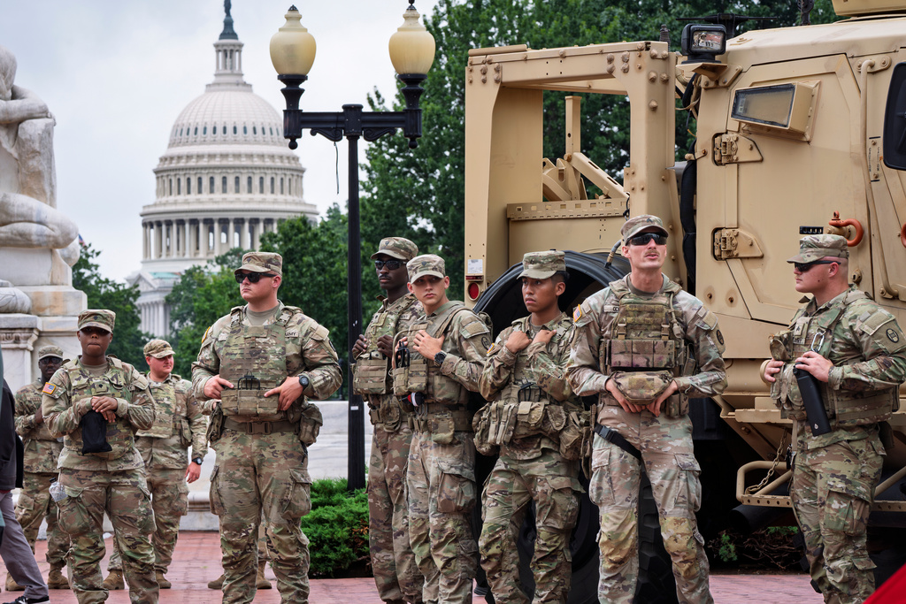 FILE - National Guard troops congregate at the entrance to Union Station in Washington, Aug. 20, 2025. (AP Photo/J. Scott Applewhite, FIle)