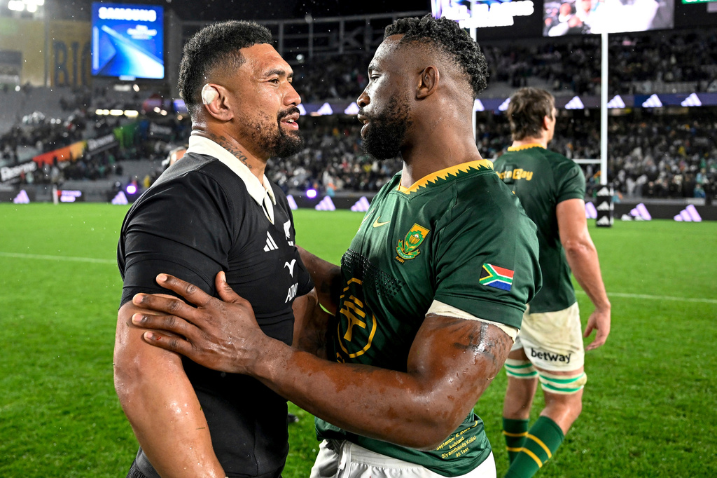FILE -Ardie Savea, left, of New Zealand and Siya Kolisi of South Africa talk following their rugby international at Eden Park in Auckland, New Zealand, Sept. 6, 2025. (Andrew Cornaga/Photosport via AP, File)