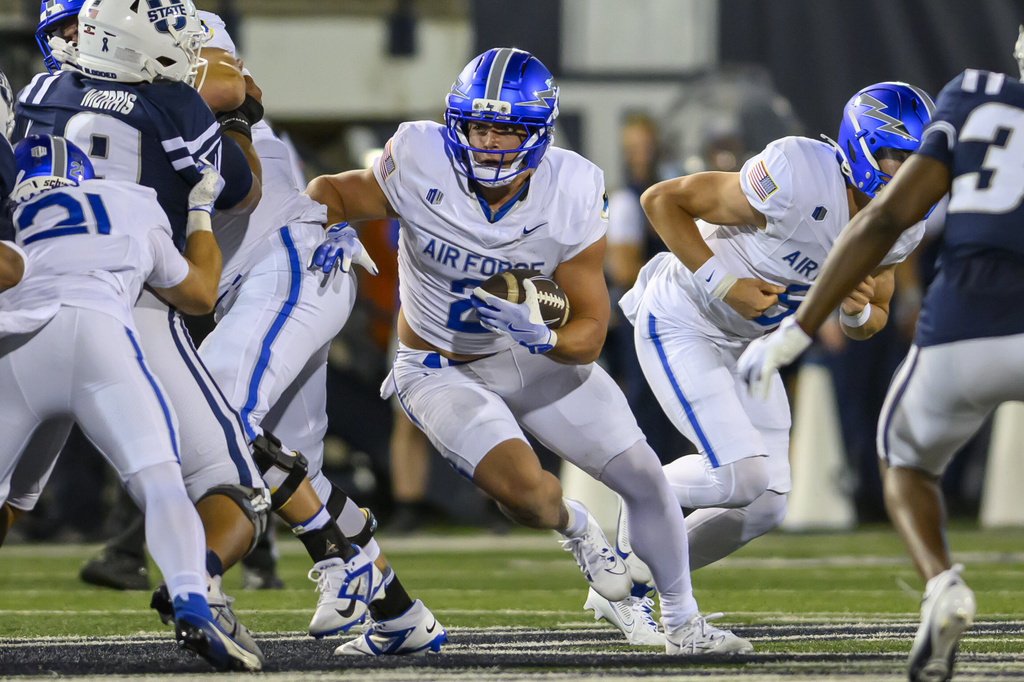 Air Force running back Owen Allen (2) runs the football during the first half of an NCAA college football game against Utah State, Saturday, Sept. 13, 2025, in Logan, Utah. (AP Photo/Tyler Tate)