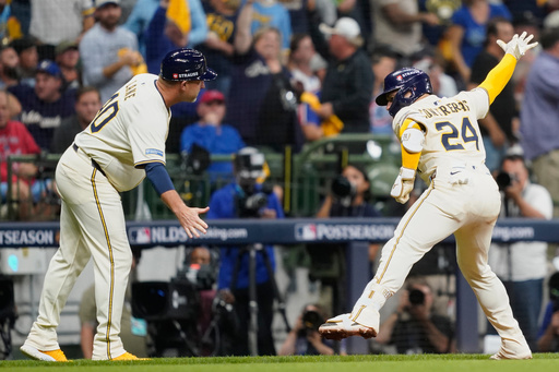 Milwaukee Brewers' William Contreras (24) celebrates with third base coach Jason Lane (40) after hitting a solo home run during the third inning of Game 2 of baseball's National League Division Series against the Chicago Cubs Monday, Oct. 6, 2025, in Milwaukee. (AP Photo/Kayla Wolf) Milwaukee Brewers' William Contreras (24) celebrates with third base coach Jason Lane (40) after hitting a solo home run during the third inning of Game 2 of baseball's National League Division Series against the Chicago Cubs Monday, Oct. 6, 2025, in Milwaukee. (AP Photo/Kayla Wolf)