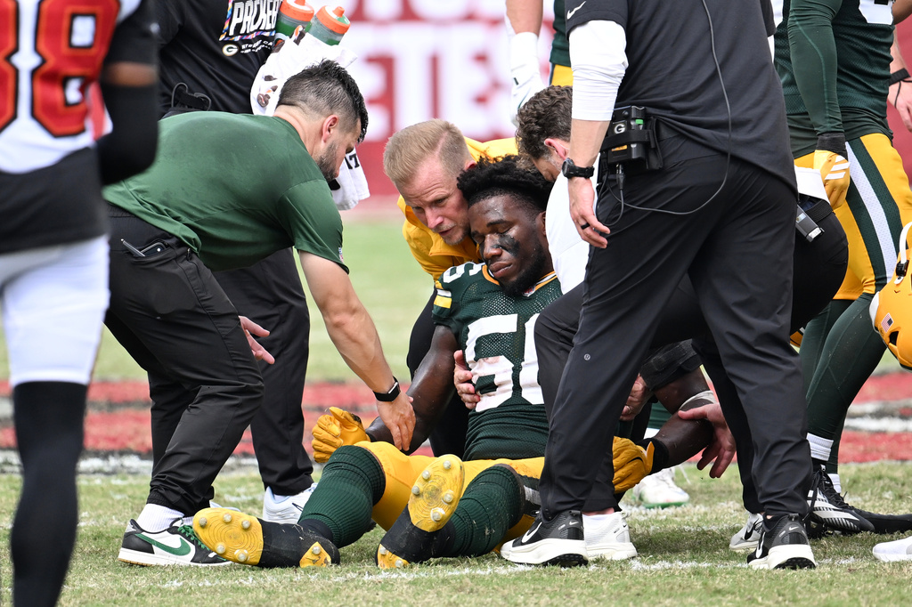 Green Bay Packers linebacker Edgerrin Cooper (56) is assisted off the field during the second half of an NFL football game against the Tampa Bay Buccaneers in Tampa, Fla., Sunday, Oct. 4, 2026. (AP Photo/Jason Behnken)
