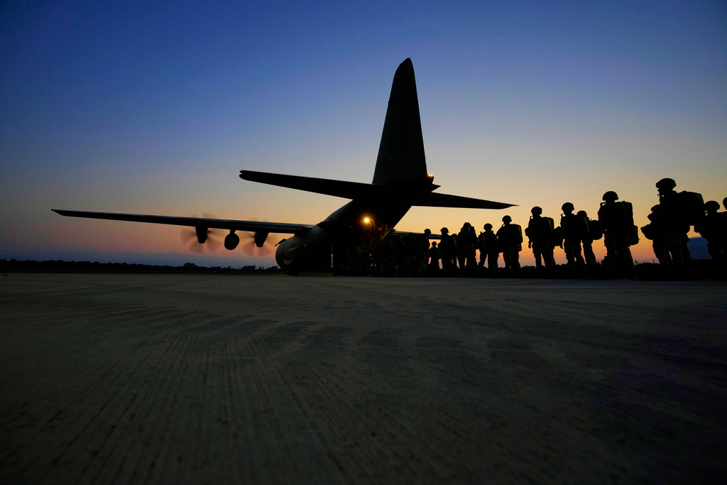 FILE - British paratroopers with the 16th Air Assault Brigade line up to board a C-130 transport aircraft at RAF Akrotiri air base in Cyprus for an airdrop over Jordan as part of a joint exercise with Jordanian soldiers, June 23, 2021. (AP Photo/Petros Karadjias, File)