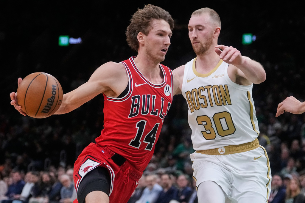 Chicago Bulls forward Matas Buzelis (14) drives to the basket against Boston Celtics forward Sam Hauser (30) during the first half of an NBA basketball game, Monday, Jan. 5, 2026, in Boston. (AP Photo/Charles Krupa)