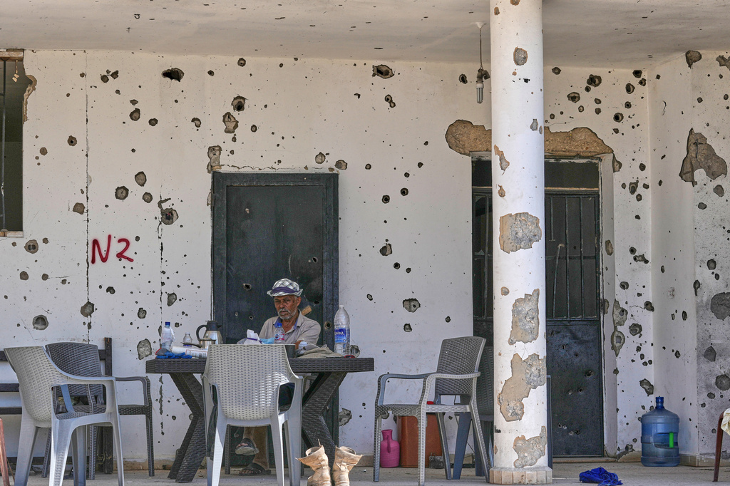 A Lebanese man sits outside his damaged house in the village of Zawtar al-Gharbieh, south Lebanon, Wednesday, Aug. 5, 2026. (AP Photo/Mohammed Zaatari)