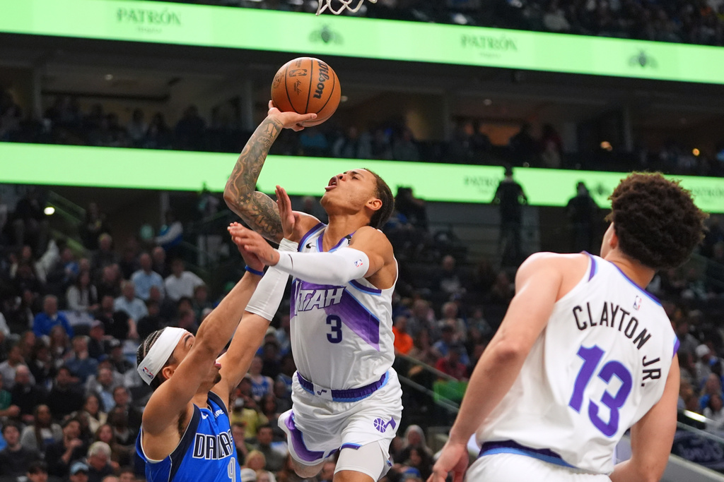 Utah Jazz guard Keyonte George (3) shoots against Dallas Mavericks guard Ryan Nembhard (9) during the first half of an NBA basketball game in Dallas, Thursday, Jan. 15, 2026. (AP Photo/LM Otero)