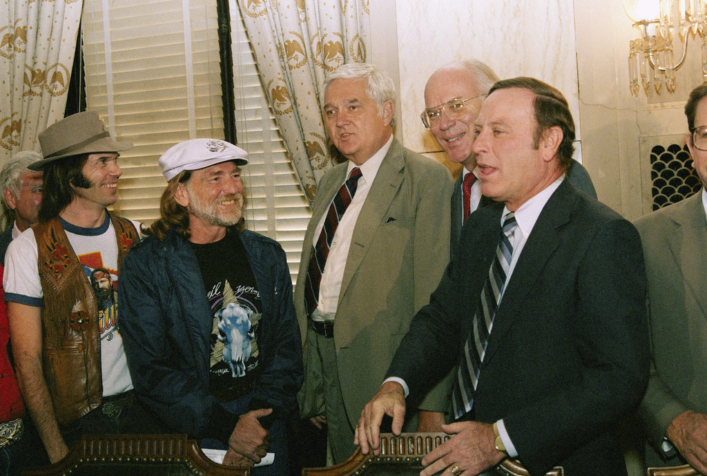 FILE - Country and Western singer Willie Nelson, second from left, and rock musician Neil Young, left, meet with members of the Senate Agriculture Committee, Sen. Mark Andrews, R-N.D.; Patrick Leahy, D-Vt.; and Alan Dixon, D-Ill. , on Capitol Hill Sept. 20, 1985 in Washington. (AP Photo/Scott Stewart, file)