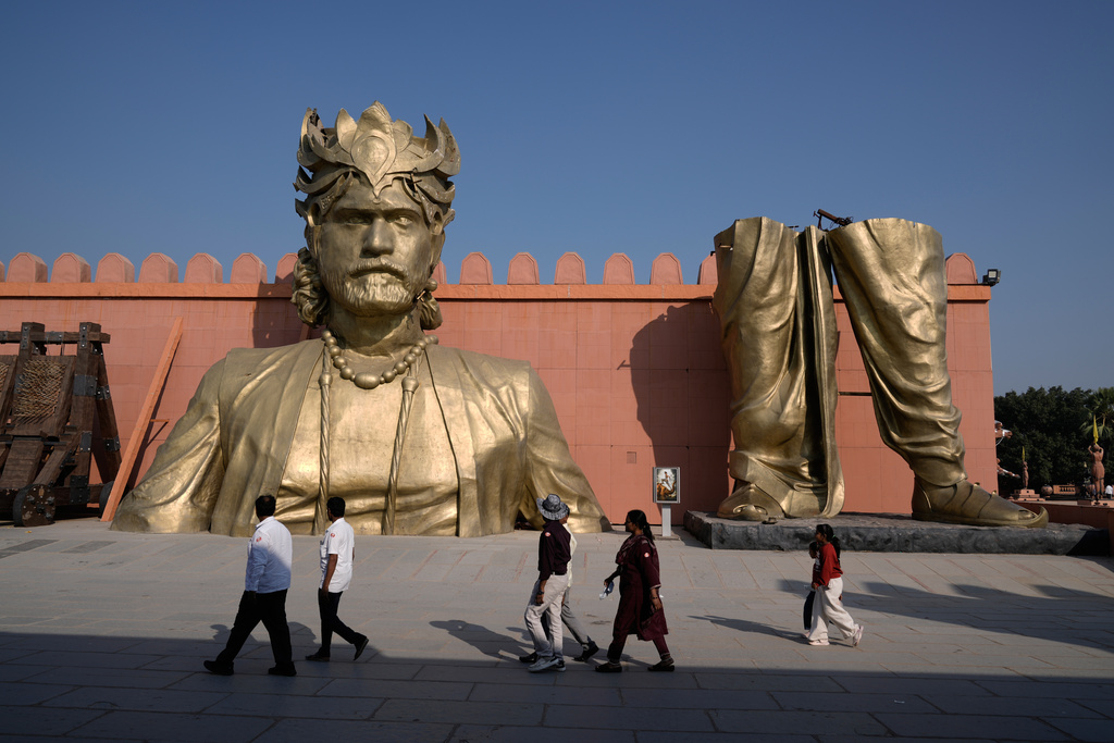 Visitors walk past the set of Bahubali in Ramoji Film City, in Hyderabad, India, Tuesday, Nov. 18, 2025. (AP Photo/Mahesh Kumar A.)