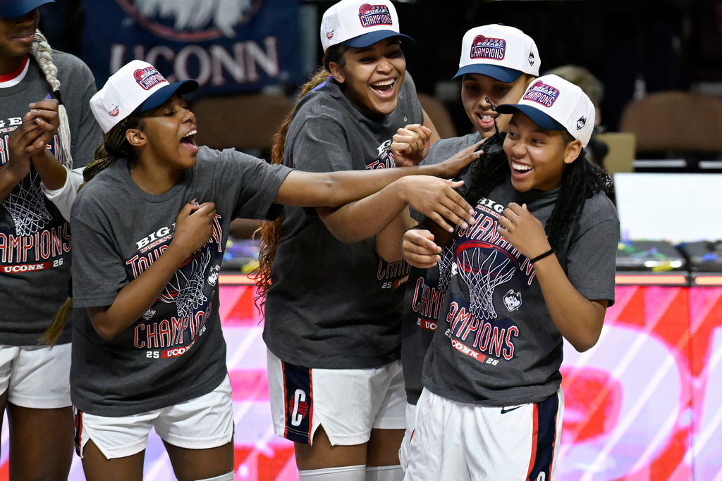 UConn's Kelis Fisher, left, Sarah Strong, second from left, and Azzi Fudd, second from right, acknowledge KK Arnold, right, as they celebrate winning an NCAA college basketball game against Villanova in the finals of the Big East tournament, Monday, March 9, 2026, in Uncasville, Conn. (AP Photo/Jessica Hill)