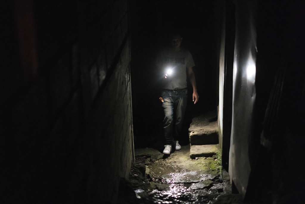 A man walks while shining his flashlight during a blackout in Santo Domingo, Dominican Republic, Tuesday, Nov. 11, 2025. (AP Photo/Ricardo Hernandez)