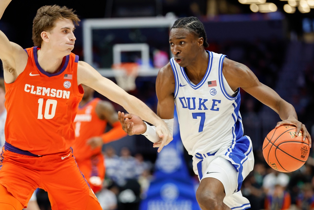 Duke guard Dame Sarr (7) drives to the basket against Clemson forward Jake Wahlin (10) during the first half of an NCAA college basketball game in the semifinals of the Atlantic Coast Conference tournament in Charlotte, N.C., Friday, March 13, 2026. (AP Photo/Nell Redmond)