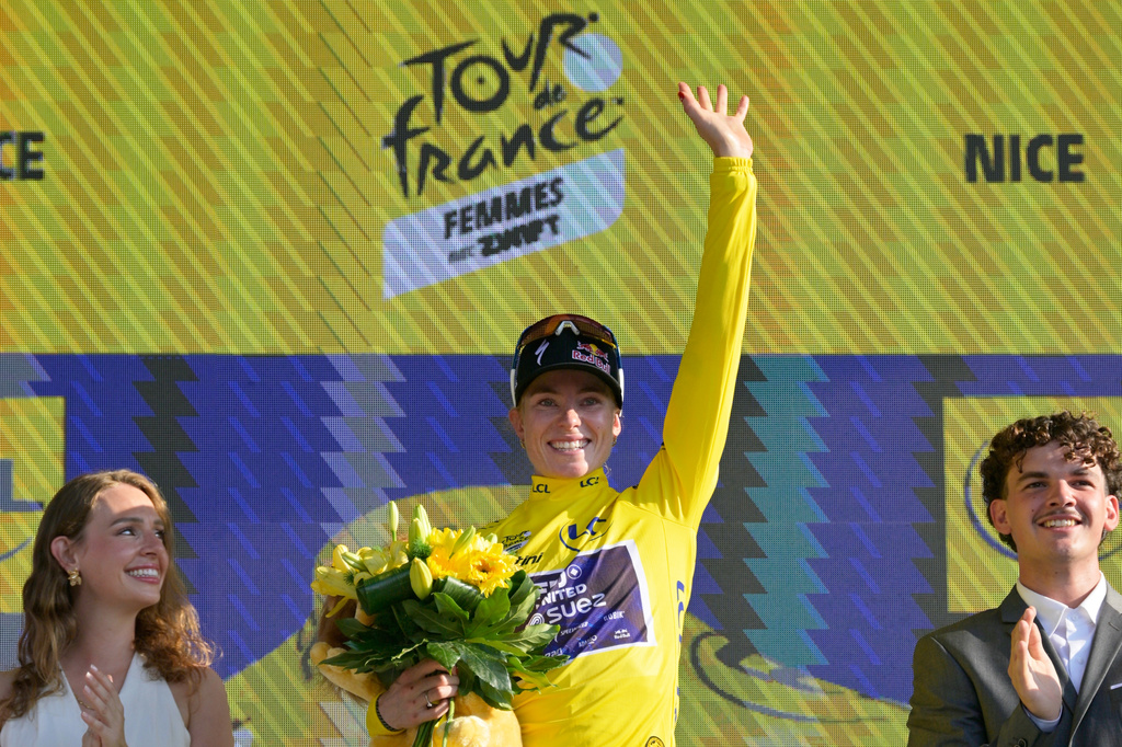 The overall leader Netherlands' Demi Vollering celebrates on the podium with the yellow jersey after the eighth stage of the Women's Tour de France cycling race (Tour de France Femmes) between Sisteron and Nice in Nice, France, Saturday, Aug. 8, 2026. (AP Photo/Philippe Magoni)
